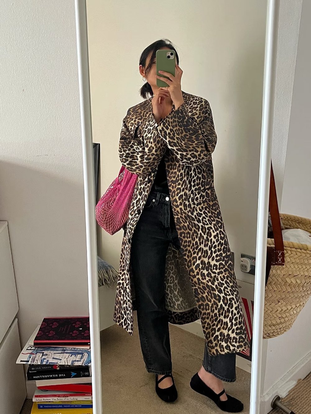 Leopard print longline coat over black jeans with a pink net bag and black mary janes